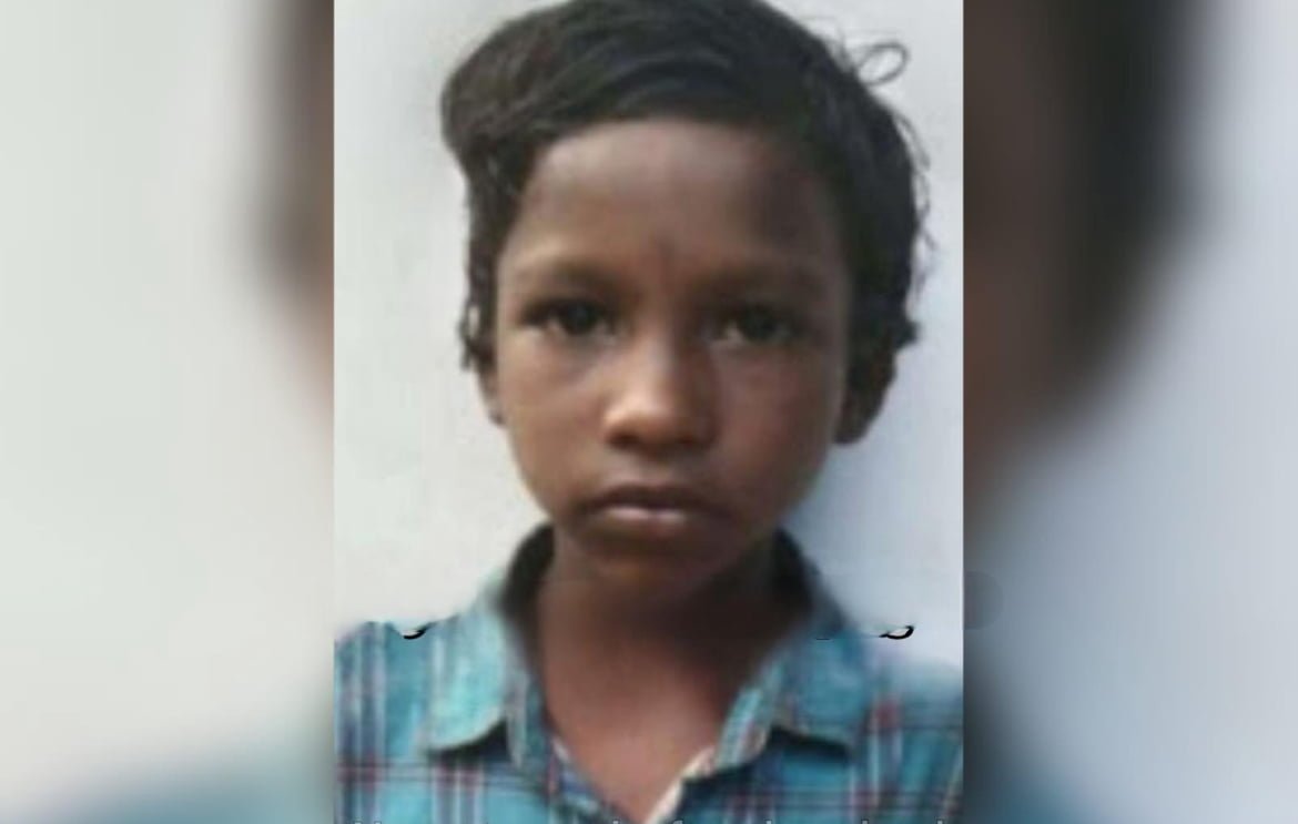 A ten-year-old hanging from a kitchen window.